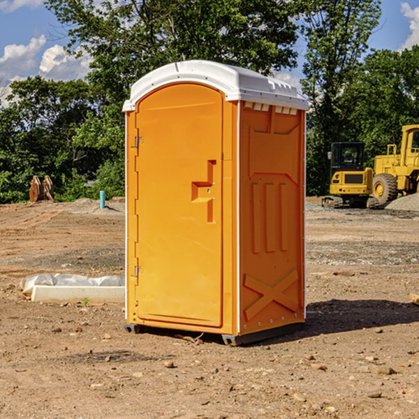 what is the cost difference between standard and deluxe portable restroom rentals in Cushing